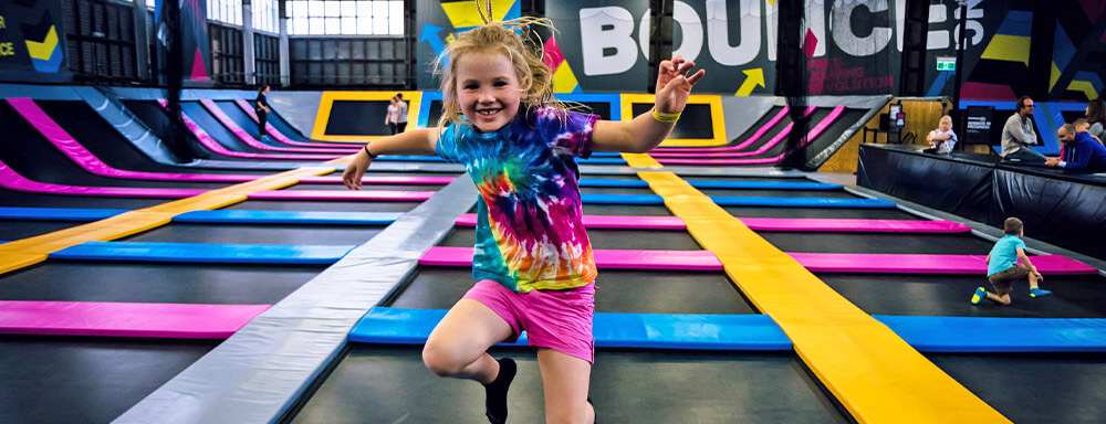 Kid jumping at bounce trampoline